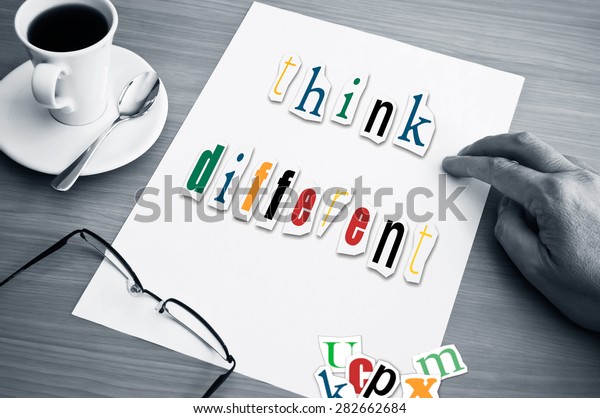 concept office cup of coffee and word think\
different on white\
page\
