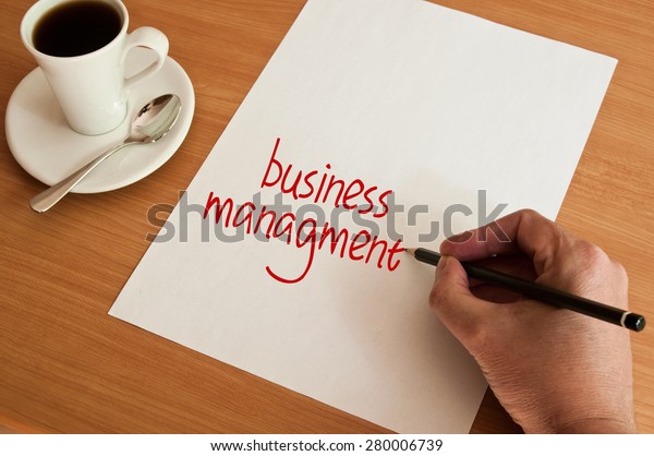 concept office cup of coffee and  words business\
management on white\
page\
