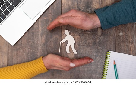 Concept Of Old Age Insurance With Hands In A Protective Gesture