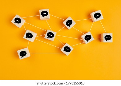 Concept of online communication or social networking. Wooden cubes with speech bubbles linked to each other with lines.  - Shutterstock ID 1793155018