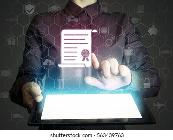 Concept of online learning. Person  touches to certificate icon  (diploma). She  holds tablet pc, that contains a many different online services. - Powered by Shutterstock