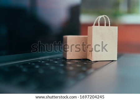 Concept online Sopping. boxes and shopping bag on laptop keyboard.