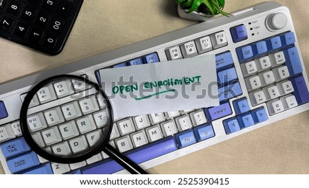 Concept of Open Enrollment write on sticky notes isolated on Wooden Table.