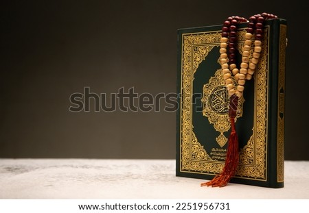  Concept: open Quran book  local language holy prayers for god,Coran - holy book of Muslims religion,
Friday month of 1444 Puasa Ramadan religion Islamic worshiping faith and learn Koran and rosary 