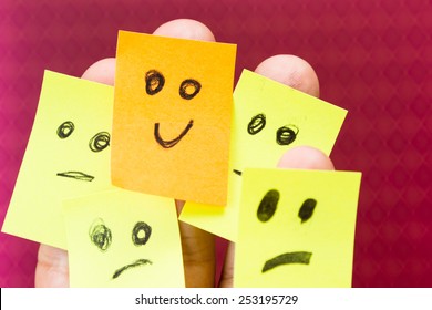 Concept For Optimism With Paper Faces On Multiple Fingers One With A Happy Good Attitude