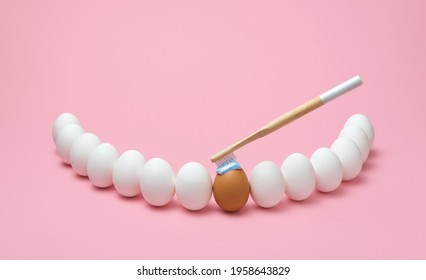 Concept for oral hygiene with a wooden toothbrush, toothpaste, and several eggs simulating the human teeth. Brushing teeth with a wooden toothbrush. - Shutterstock ID 1958643829