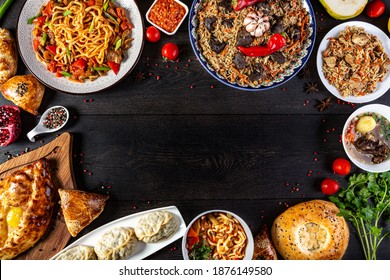 The concept of oriental cuisine. Assorted Uzbek food set, pilaf, samsa, lagman, manta, shurpa central asia food. Homemade Uzbek pilaf or plov from lamb served in cast iron cookware