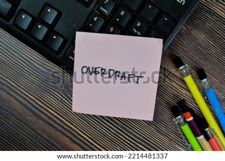 Concept of Overdraft write on sticky notes isolated on Wooden Table.