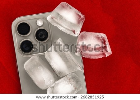 The concept of overheating and fire hazard. Cooling the latest smartphone with ice cubes. Excessive processor operating temperature damages the Phone.