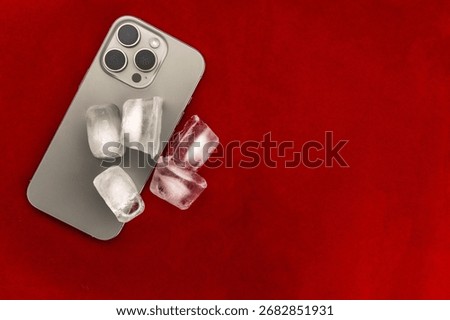 The concept of overheating and fire hazard. Cooling the latest smartphone with ice cubes. Excessive processor operating temperature damages the Phone.