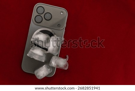 The concept of overheating and fire hazard. Cooling the latest smartphone with ice cubes. Excessive processor operating temperature damages the Phone.