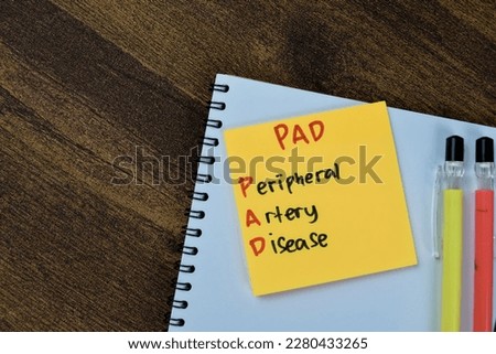 Concept of PAD - Peripheral Artery Disease write on sticky notes isolated on Wooden Table.