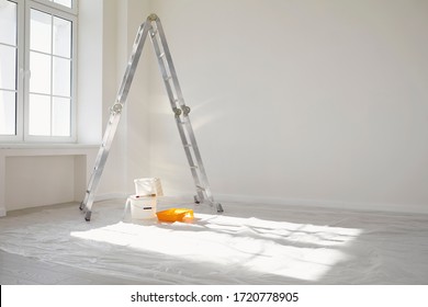 Concept painting work repair painting. Ladder paint cans in a white room for repair