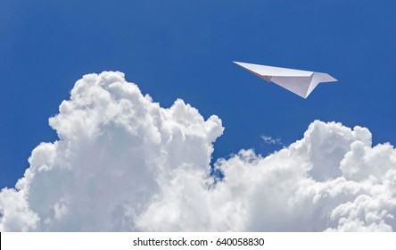 Concept Paper Airplane And Blue Sky Background