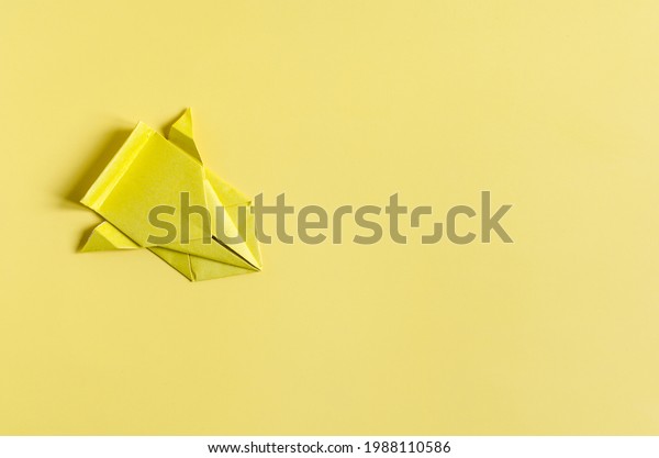 Concept paper car in\
yellow color on a bright yellow background close-up. Origami\
colored paper racing\
cars