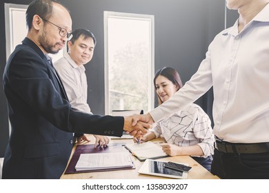concept of partner succession of contract business ; business handshaking process after successful deal of meeting with partner