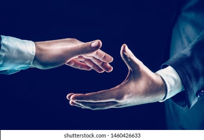 concept of partnership in business:two businessmen stretches his