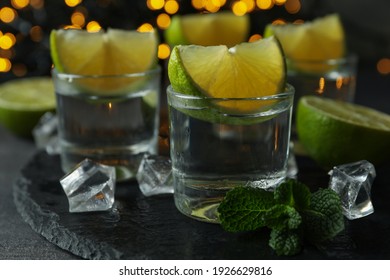 Concept of party drink with shots of vodka and blurred lights