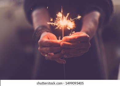 Concept of party nightlife and new year eve 2020 - close up of people hands with red fire sparklers to celebrate the night and the new start - warm colors filter - joy and hope concept life - Powered by Shutterstock