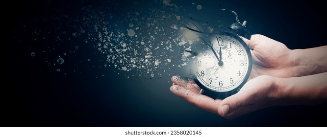 Concept of passing away, the clock breaks down into pieces. Hand holding analog clock with dispersion effect, copy space