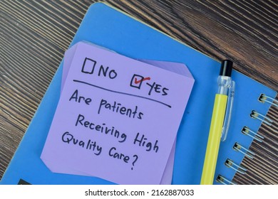 Concept Of Are Patients Receiving High Quality Care? Yes Write On Sticky Notes Isolated On Wooden Table.