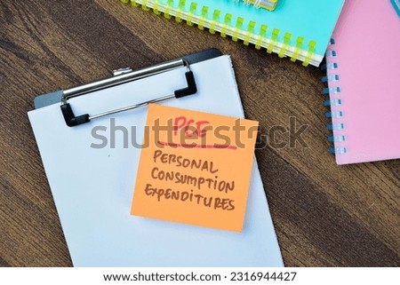 Concept of PCE - Personal Consumption Expenditures write on sticky notes isolated on Wooden Table.