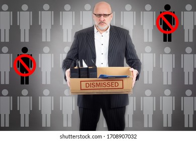 Concept Of Personnel Policy Of The Enterprise. A Man With A Box In His Hands Is Dismissed From Work. List Of Candidates For Dismissal. Job Loss. Loss Of Livelihood. Stress From Losing Your Job.