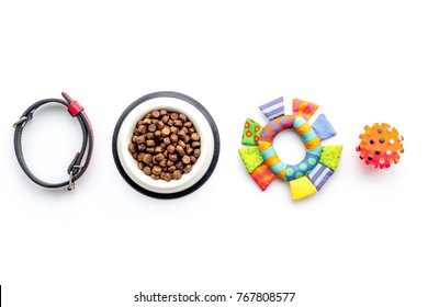 Concept Pet Care, Playing And Training. Toys, Accessories And Feed On White Background Top View Copyspace