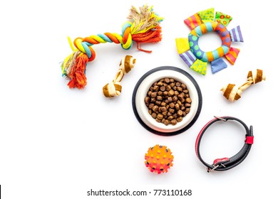Concept pet care, playing and training. Toys, accessories and feed on white background top view copyspace