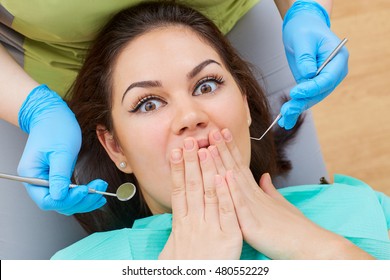 Concept Phobia Dentist, Dental Office. Young Girl At The Dentist Does Not Want Dental Treatment, Fear Of Dental Instruments.