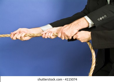 concept photo of business people using a rope as teamwork.
