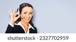 Concept photo - client support, advisor phone operator in headset show make ok okay hand sign, isolated gray background. Consulting and assistance service call center. Answer, help, advertise.