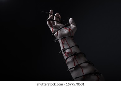 Concept Photo Of A Hand And Arm Tied With Barbed Wire In Studio Artistic Conversion