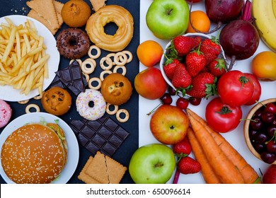 Concept photo of healthy and unhealthy food. Fruits and vegetables vs donuts,sweets and burgers - Shutterstock ID 650096614