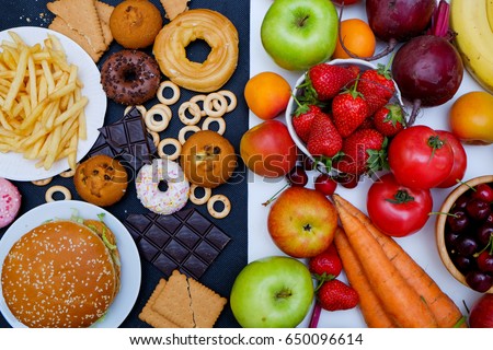 Concept photo of healthy and unhealthy food. Fruits and vegetables vs donuts,sweets and burgers