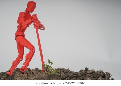 foto conceptual de un hombre plantando un cultivo, un maniquí con una pala y una planta
