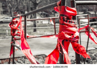 Concept Photo Of Restricted Area With Red Caution Warning Markup Tape And Monochrome Street Background.