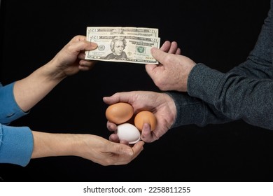 A concept photo showing just how expensive eggs are by exchanging three eggs for cash.