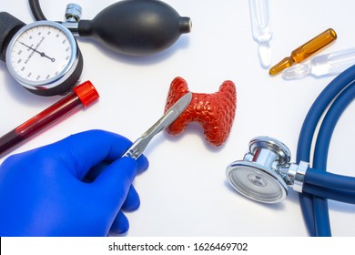 Concept photo of thyroid surgery, operation on thyroid or parathyroid gland. Doctor with scalpel in hand makes incision in figure of human thyroid, which is located near medical toolkit - stethoscope