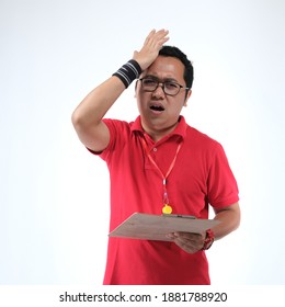 Concept Photography Of Southeast Asian Business Coach With Red Shirt - Hit Head Because Of The Score Not Good And Look At The Camera.