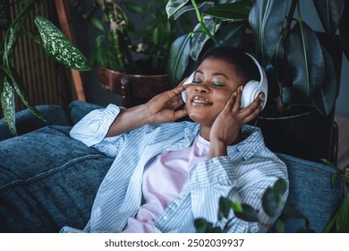 Concept of pleasure, morning routine, day start, relaxation and meditation at home. Healthy lifestyle. Young calm African American woman relaxing. Mindfulness, wellbeing, work life balance - Powered by Shutterstock