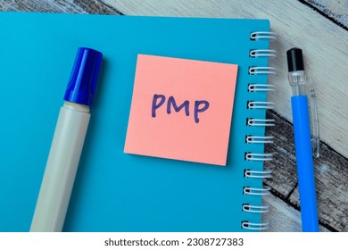 Concept of PMP write on sticky notes isolated on Wooden Table.