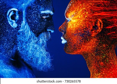 Concept. Portrait of a bearded man and woman painted in ultraviolet powder.