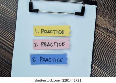 Concept of Practice, Practice, Practice write on sticky notes isolated on Wooden Table.
