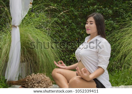 Concept of pregnancy.  Pregnant women are exercising. Pregnant women are taking care of their health with yoga. Pregnant woman playing yoga in the garden Stock photo © 