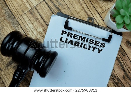 Concept of Premises Liability write on paperwork isolated on Wooden Table.