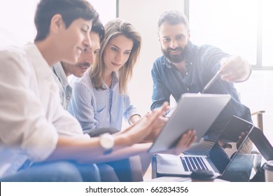 Concept of presentation new business project.Group of young coworkers discussing ideas with each other in modern office.Business people using electronic devices.Horizontal, blurred background - Shutterstock ID 662834356