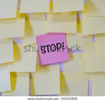 Concept of priority, stop is written on red sticky notes within many sticky notes.
                               
