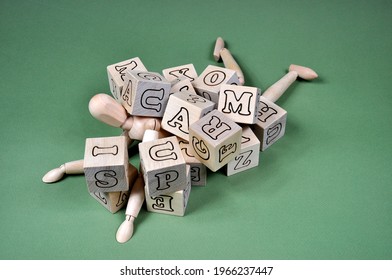 The concept of the problem of receiving spam. A wooden man littered with cubes and the inscription SPAM. - Powered by Shutterstock