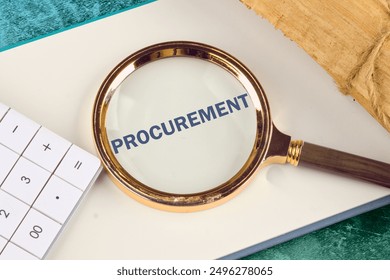 Concept of procurement. PROCUREMENT appeared through a magnifying glass in a notebook, close-up. View from above